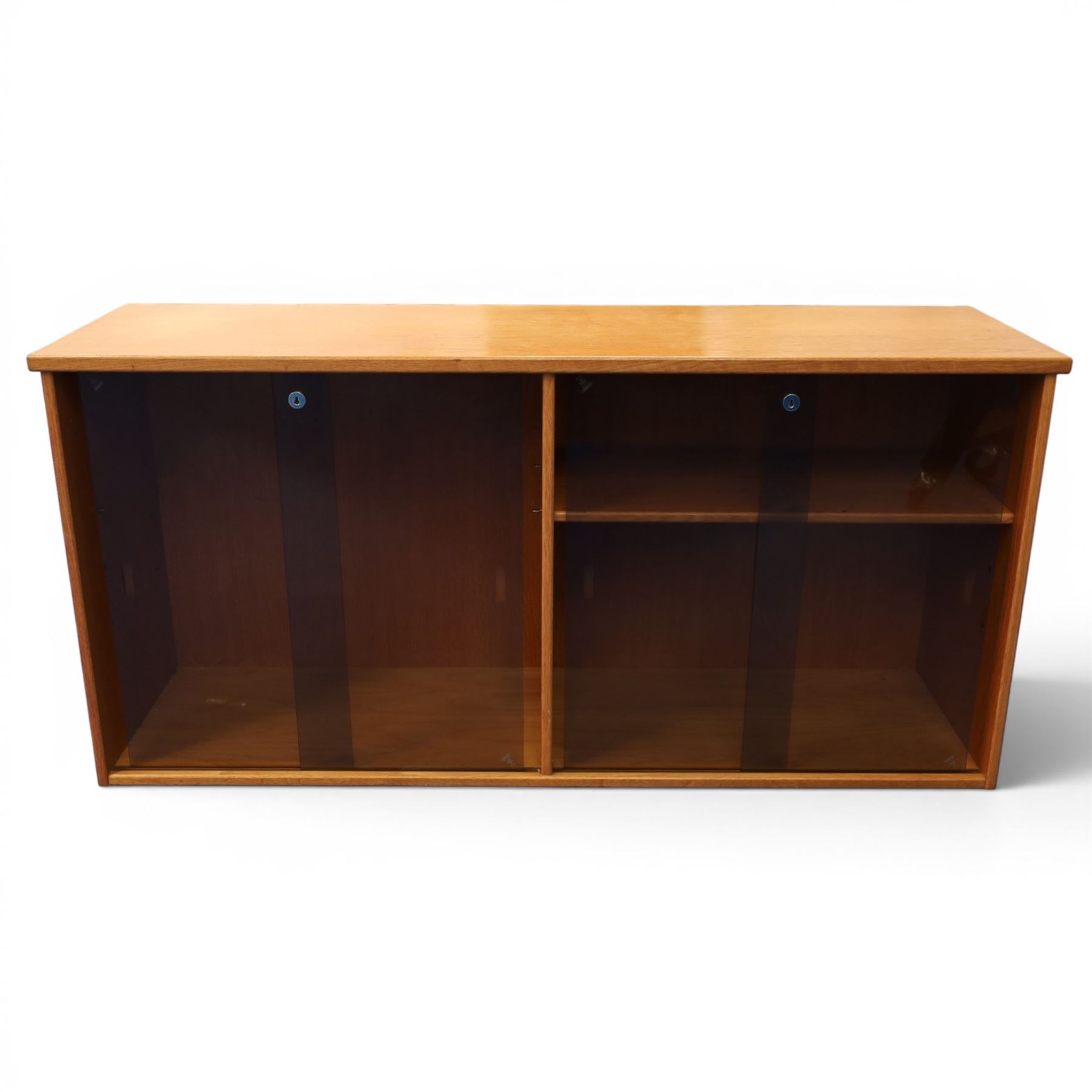 Light oak bookcase cabinet, fitted with four sliding tinted glass doors