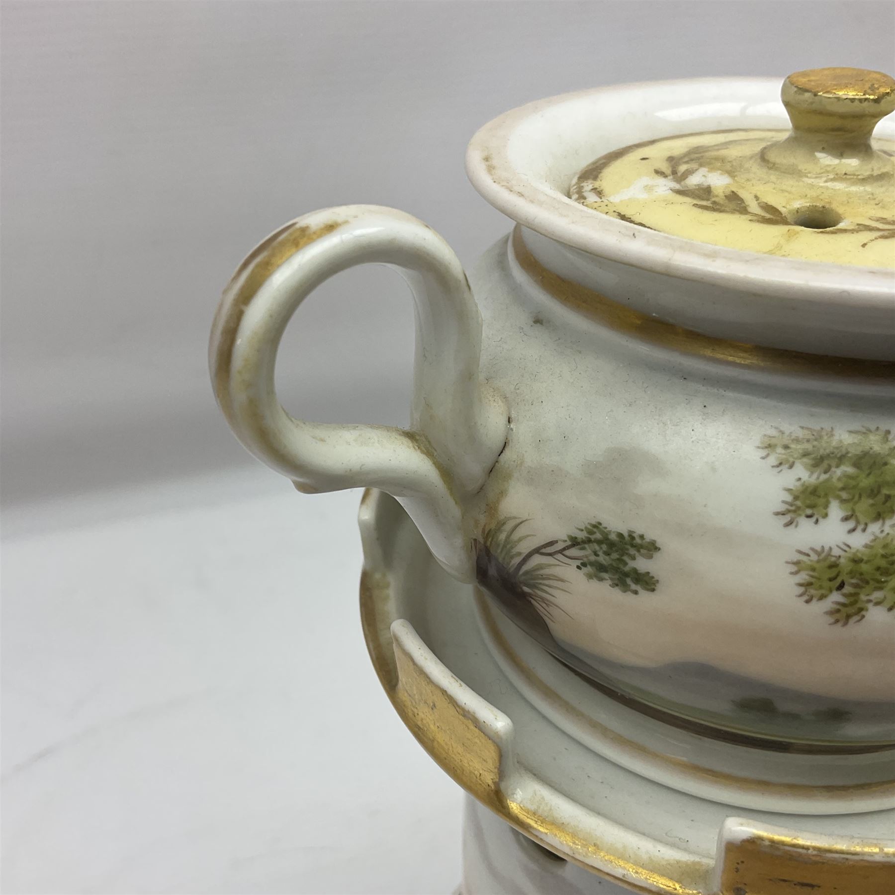 Two 19th century continental teapots and warmers, each teapot upon a cylindrical warming base, hand printed with landscapes and seascapes, largest H22cm