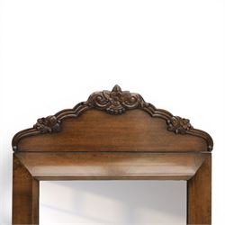 Late 19th century walnut dressing mirror, rectangular mirror plate within a moulded frame, shaped carved crest with floral and foliate detail