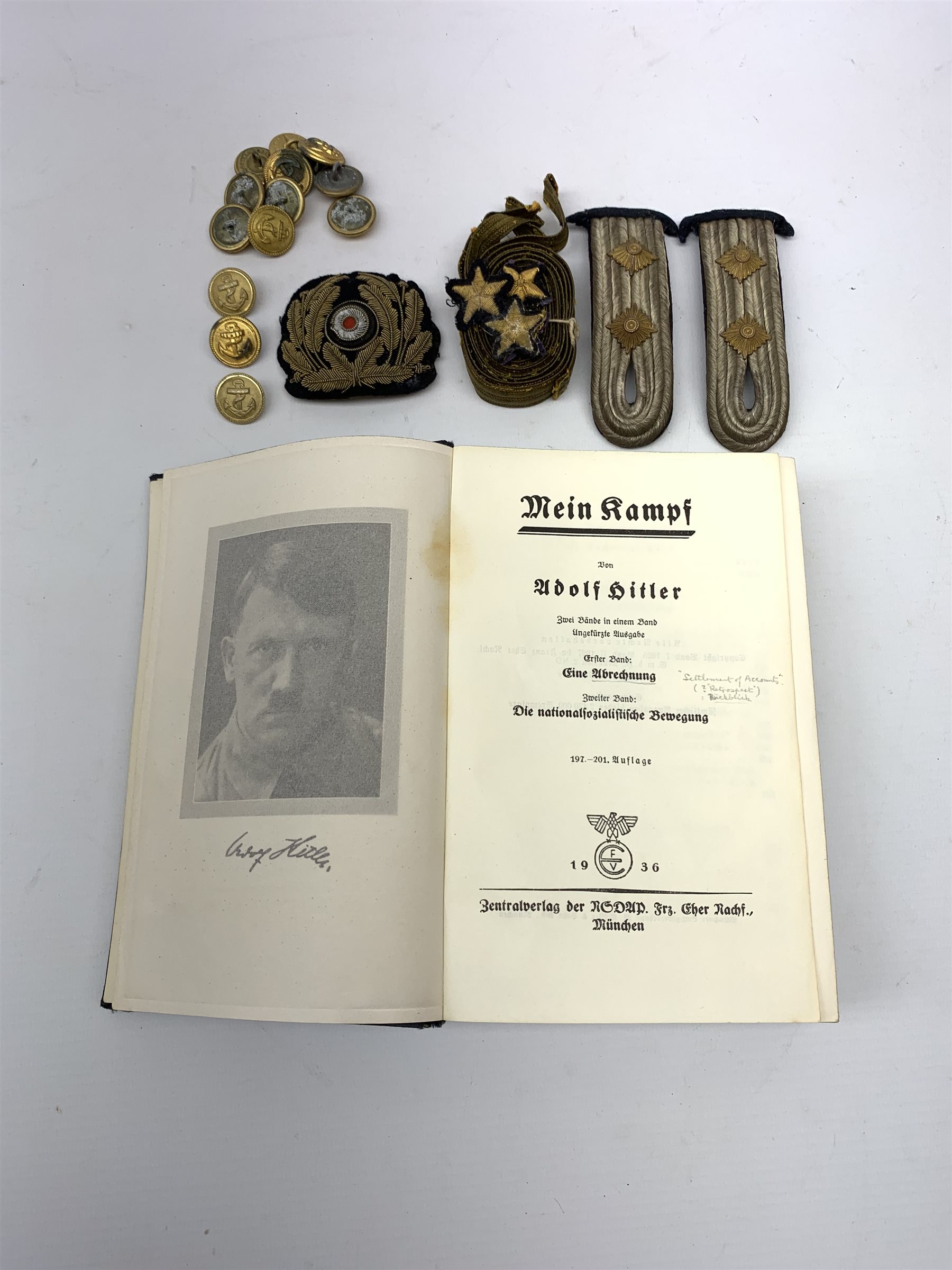 WW2 Kreigsmarine uniform accessories from prisoner of war U-boat Kapitanleutnant Gunther Lorenz comprising cap badge, pair of epaulettes, thirteen buttons marked 1940 and roll of rank braiding and stars; together with copy of Adolf Hitler's Mein Kampf. 1936 published by Zentralverlag Der NSDAP Munchen with German text.
