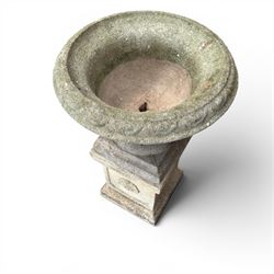 Weathered cast stone statue of a child and urn planter on pedestal along with three piece bird bath