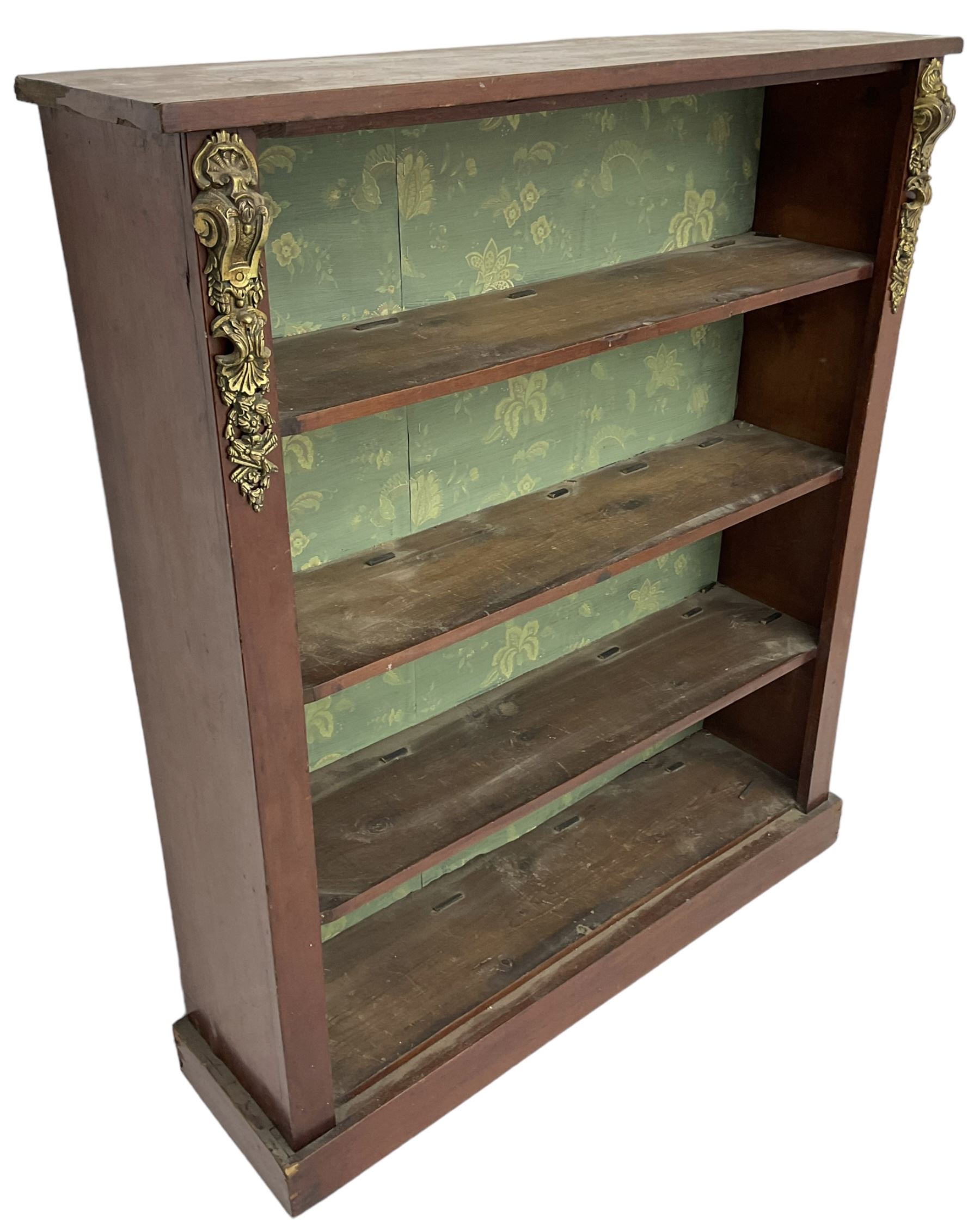 Early 20th century mahogany open bookcase, fitted with three shelves on plinth base, decorated with foliate patterned gilt metal mounts