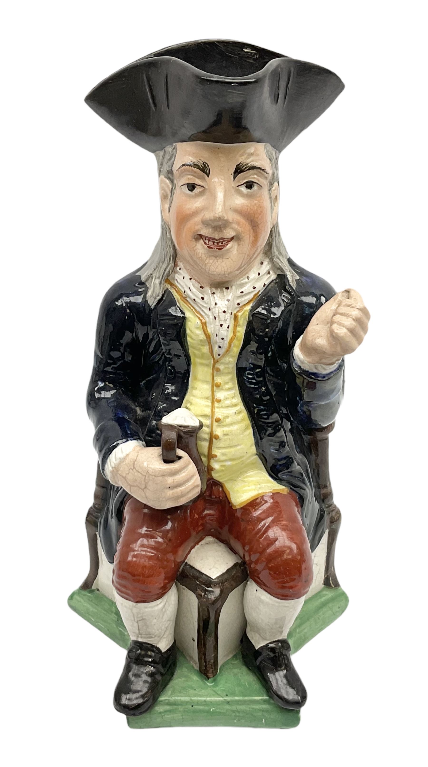 Early 20th century Staffordshire William Kent Squire toby jug, modelled seated upon a corner chair holding a jug of ale in his right hand, H28cm