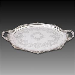 Victorian silver twin handled tray, of oval form, engraved with floral and foliate swags w...