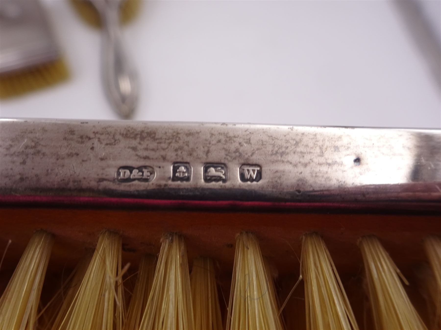 Early 20th century silver vase, of waisted form, with reed and bow border, upon knopped stem and filled circular stepped foot, hallmarked William Comyns & Sons, London 1911, H15cm, together with pair of Indian silver trumpet vases, with chased and embossed floral decoration, a pair of silver mounted clothes brushes, hallmarked Deakin & Francis Ltd, Birmingham 1946  and a 1920s silver mounted hairbrush, hallmarked W J Myatt & Co, Birmingham 1922