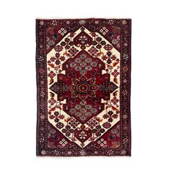 Persian Heriz wool rug, red and ivory field with floral medallion, geometric spandrels, and floral border (157cm x 107cm); Kurdish Shairwan wool rug, red and navy field with three medallions, geometric crosses and serrated border (200cm x 155cm); Persian Qashqai wool rug, golden-yellow field with boteh motifs and wide floral border (127cm x 82cm)