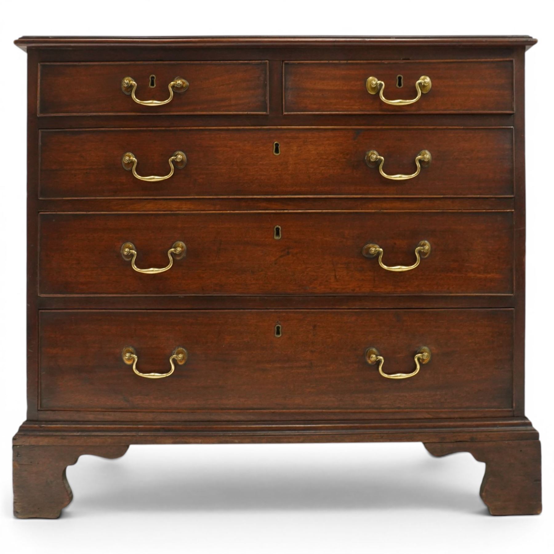 Late 18th century mahogany chest of drawers, rectangular top with moulded edge above two short and three long graduated drawers, with brass swan neck handles, shaped apron and bracket feet