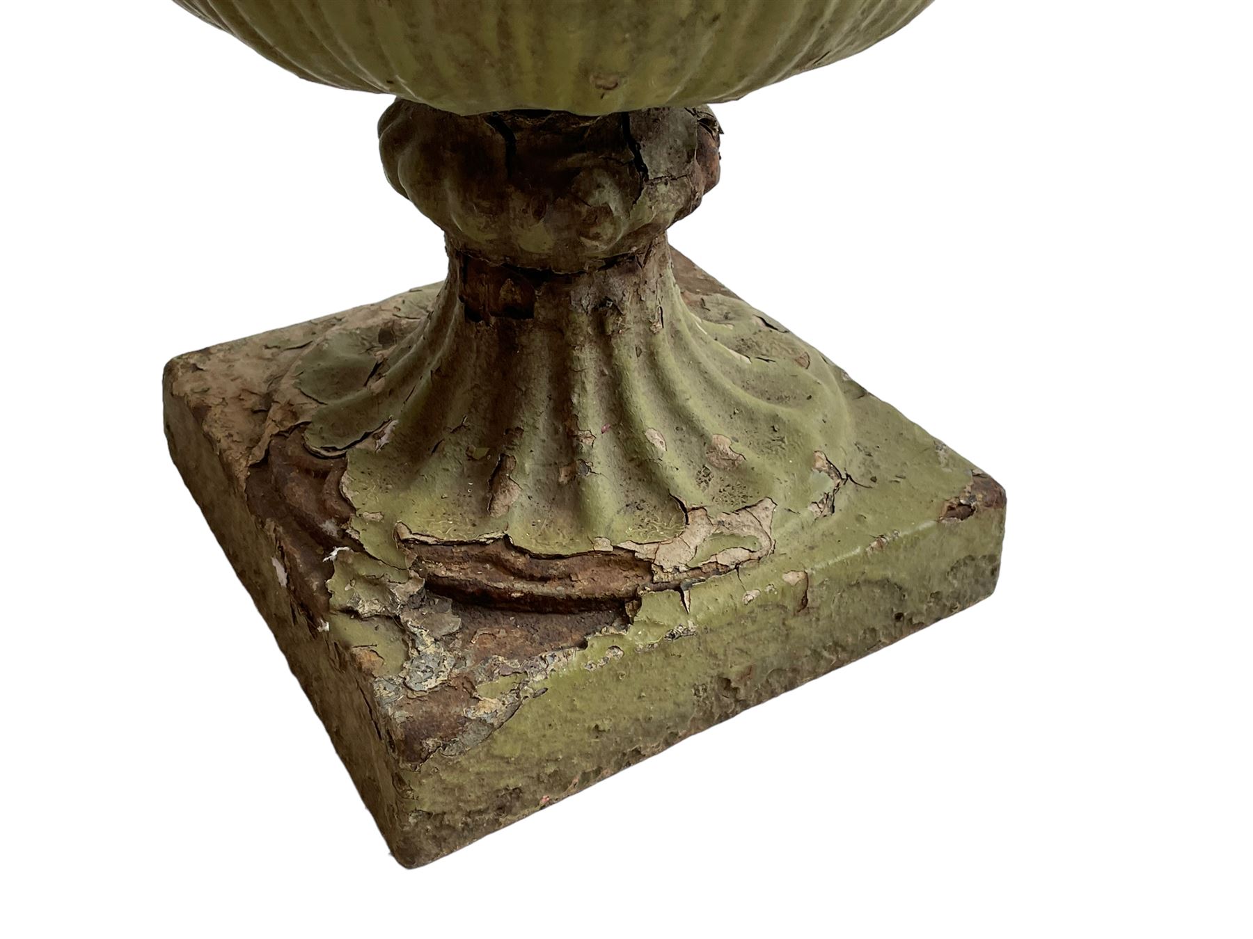 Pair of Victorian cast iron lotus garden urns, the shaped rim over lappet cast underbelly, on moulded footed base