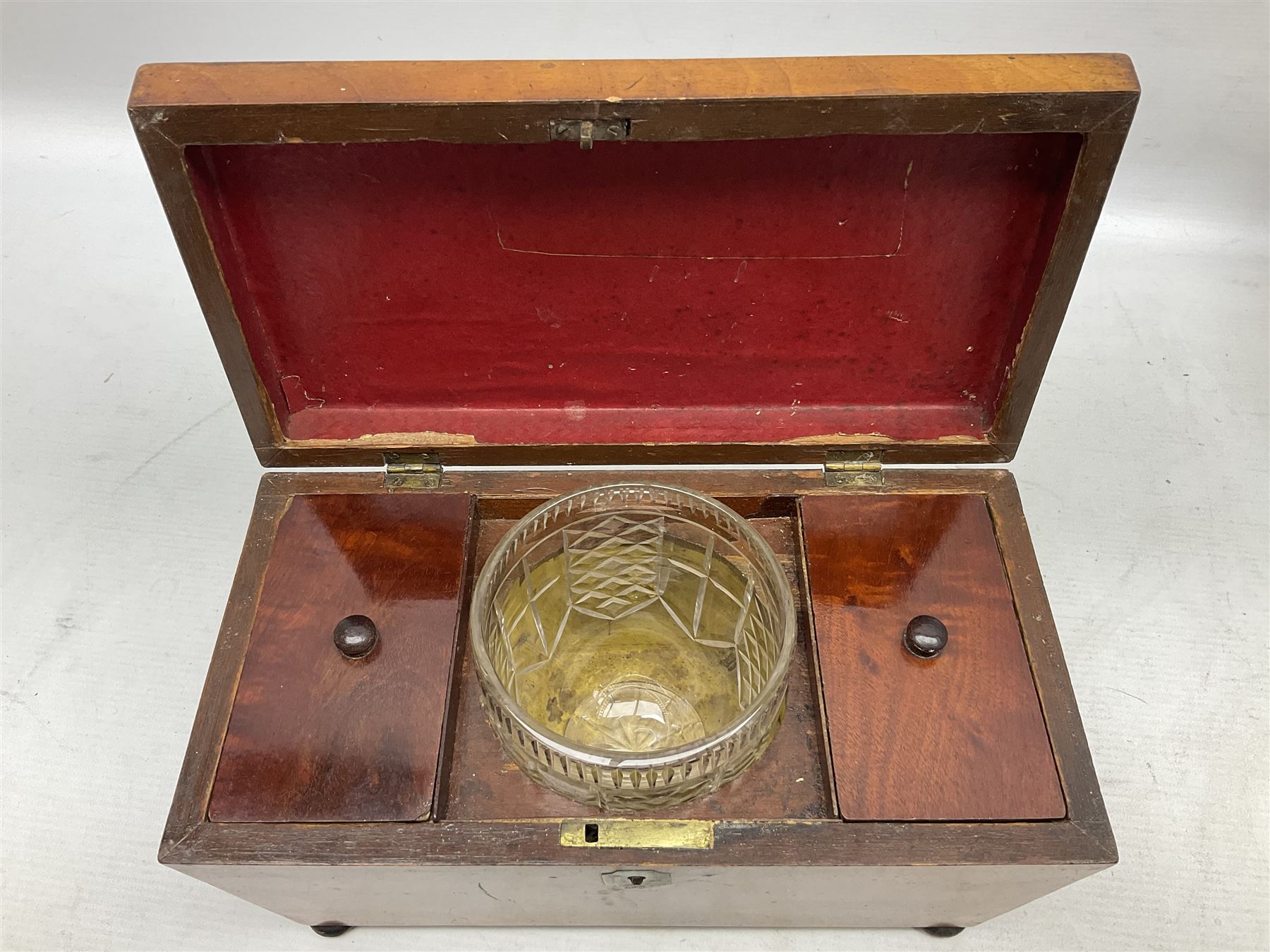 Walnut tea caddy of sarcophagus form, two division lidded interior with a later glass mixing bowl, upon four brass bun feet together with a walnut sewing box with mother of pearl inlaid decoration, tea caddy H16cm