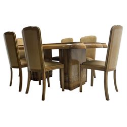 Early 20th century Art Deco walnut twin pedestal dining table, shaped top with thick crossbanding over a rounded edge, raised on two shaped pedestals (W187cm D107cm H76cm); and set of six matching dining chairs, the high back and sprung drop-in seat upholstered in walnut effect faux leather with reeded apron, raised on square supports (W47cm H97cm)