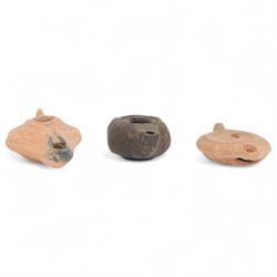 Antiquities; Greco-Roman dark glazed zoomorphic oil lamp, together with two Hellenistic te...