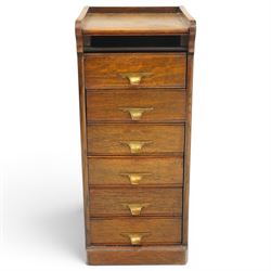 Edwardian oak pedestal filing cabinet, rectangular top with raised three-quarter gallery top, fitted with six drawers with interior paper-stays and brass handles, on plinth base