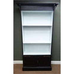  Arts & Crafts style display cabinet, projecting cornice, two adjustable shelves above two panelled doors, plinth base, W105cm, H198cm, D39cm  