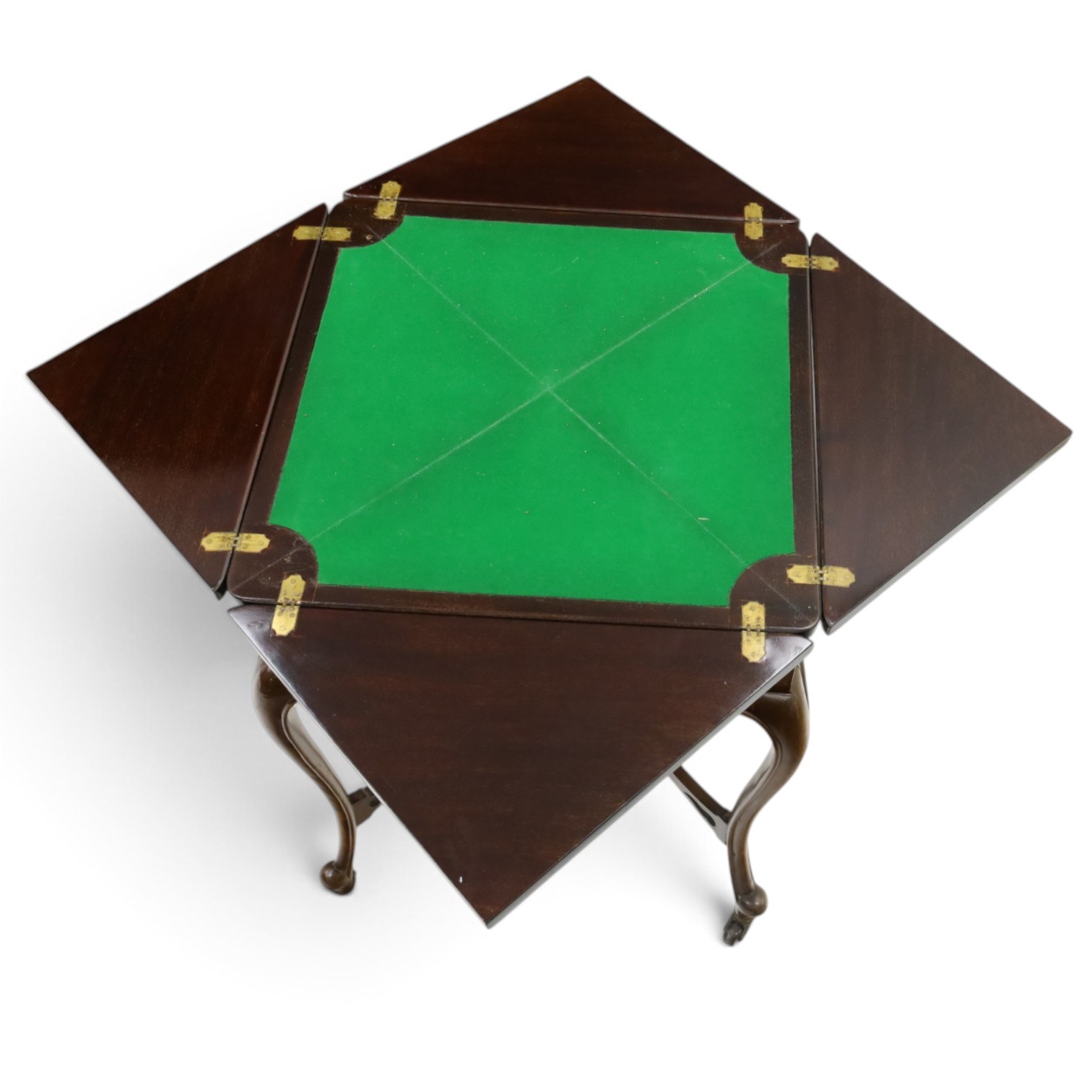 Edwardian carved mahogany envelope card table, the rectangular quadruple hinged top enclosing baize-lined interior, the single frieze drawer and sides with blind-fretwork carving, over cabriole supports with scroll feet and castors united by pierced lattice fretwork X-stretcher with turned finial