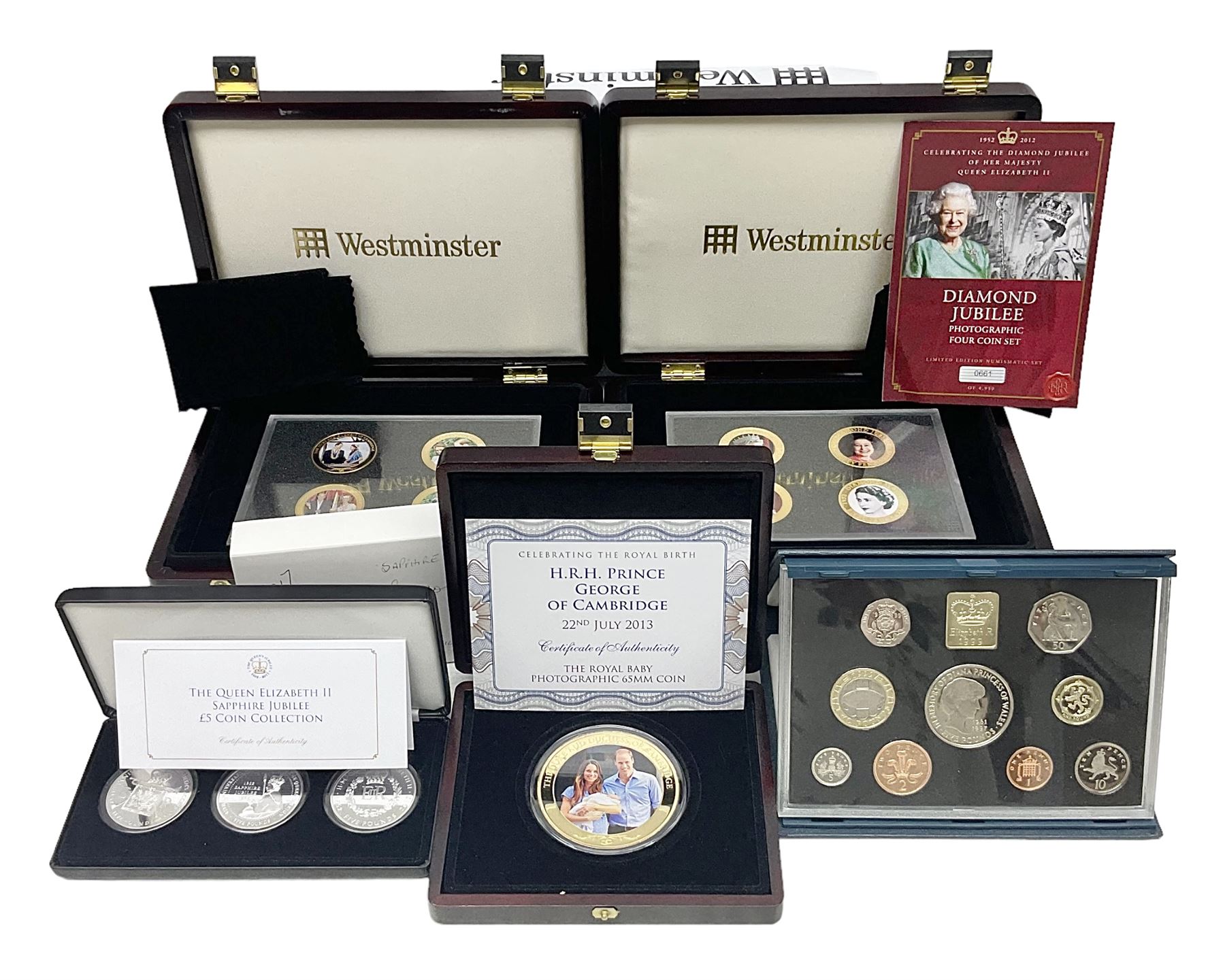 Mostly commemorative coins including The Royal Mint 1997 proof coin collection, Westminster 2013 'The Royal Baby Photographic 65mm' coin, Jubilee Mint 2017 'The Queen Elizabeth II Sapphire Jubilee' five pound coin collection etc