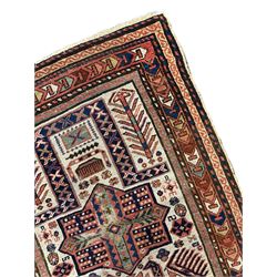 Old Caucasian rug, neural ground field decorated with three geometric medallions surrounded by stylised bird and flower head motifs, multiple border bands with geometric repeating design