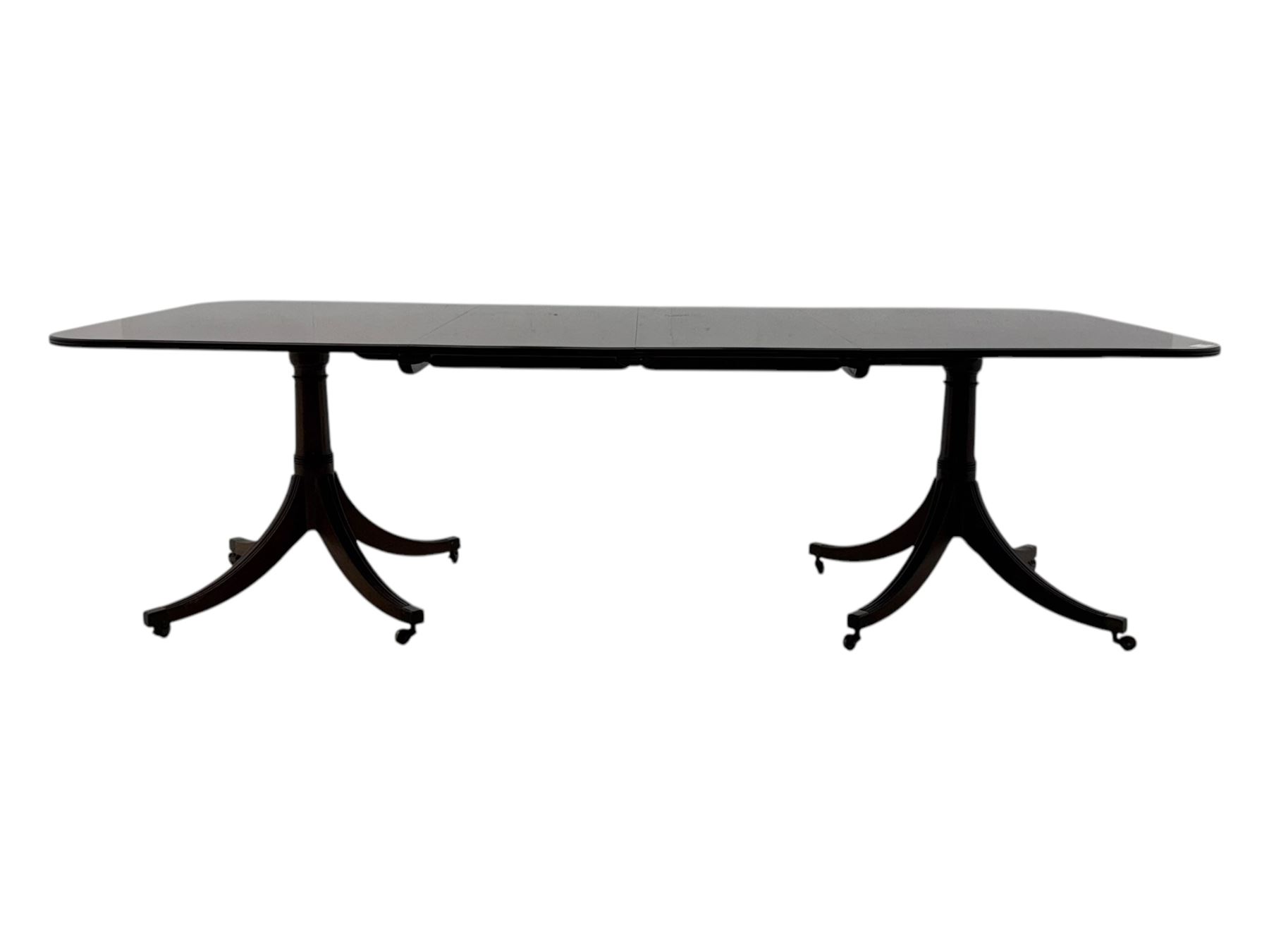 Regency design mahogany twin pillar dining table, two additional leaves, on turned supports with four out-splayed supports 