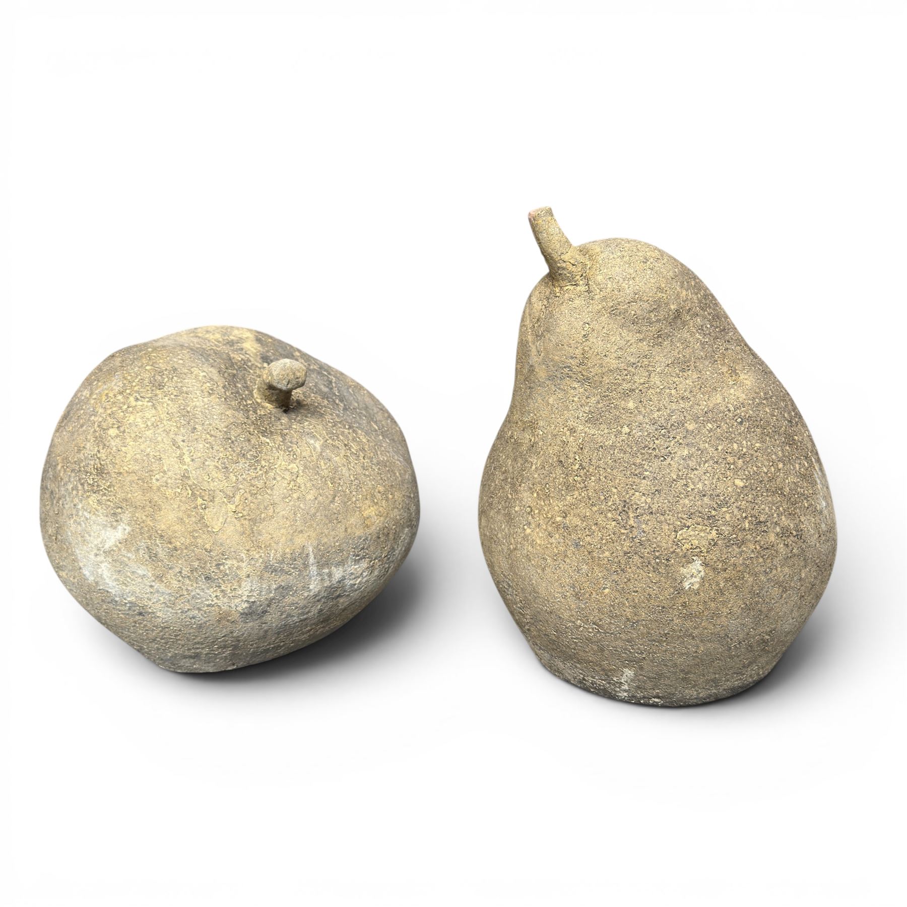 Pair of weathered cast stone garden models of fruit, in the form of an apple and pear