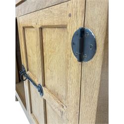 'Mouseman' oak display cabinet on cupboard, raised cabinet enclosed by two lead glazed doors, adzed oak top over double panelled cupboard, fitted with ironwork and carved with mouse signature, by Robert Thompson of Kilburn