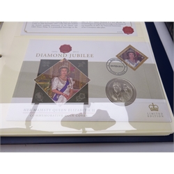 Sixteen coin covers each containing a modern commemorative coin, some being five pounds, in two ring binder folders and a ring binder folder containing first day covers (3)  