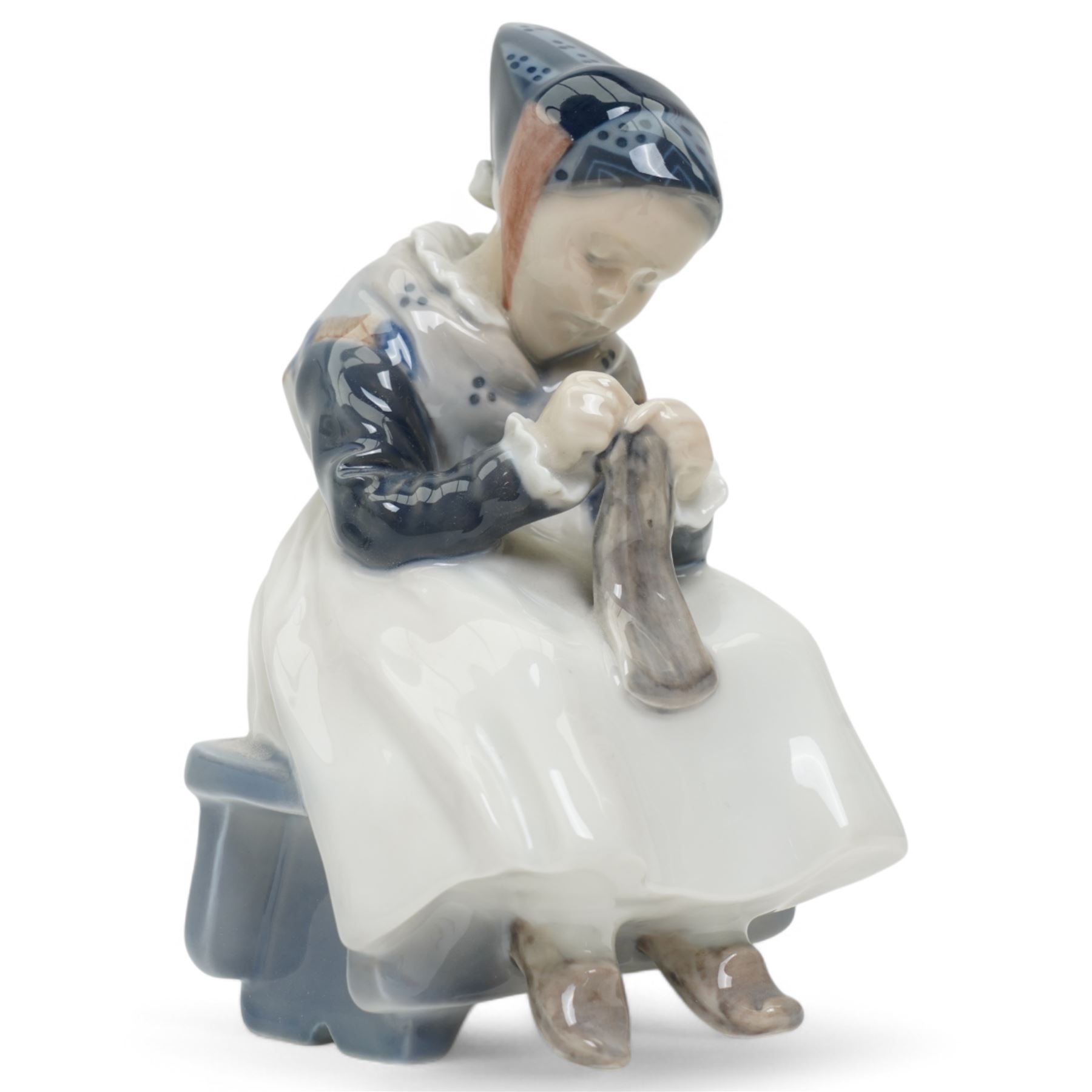 Four Royal Copenhagen figures, including Amager Girl Sewing no. 1314, Boy Whittling no. 905, Girl with Goose no. 528, and Amager Girls Reading no. 1395
