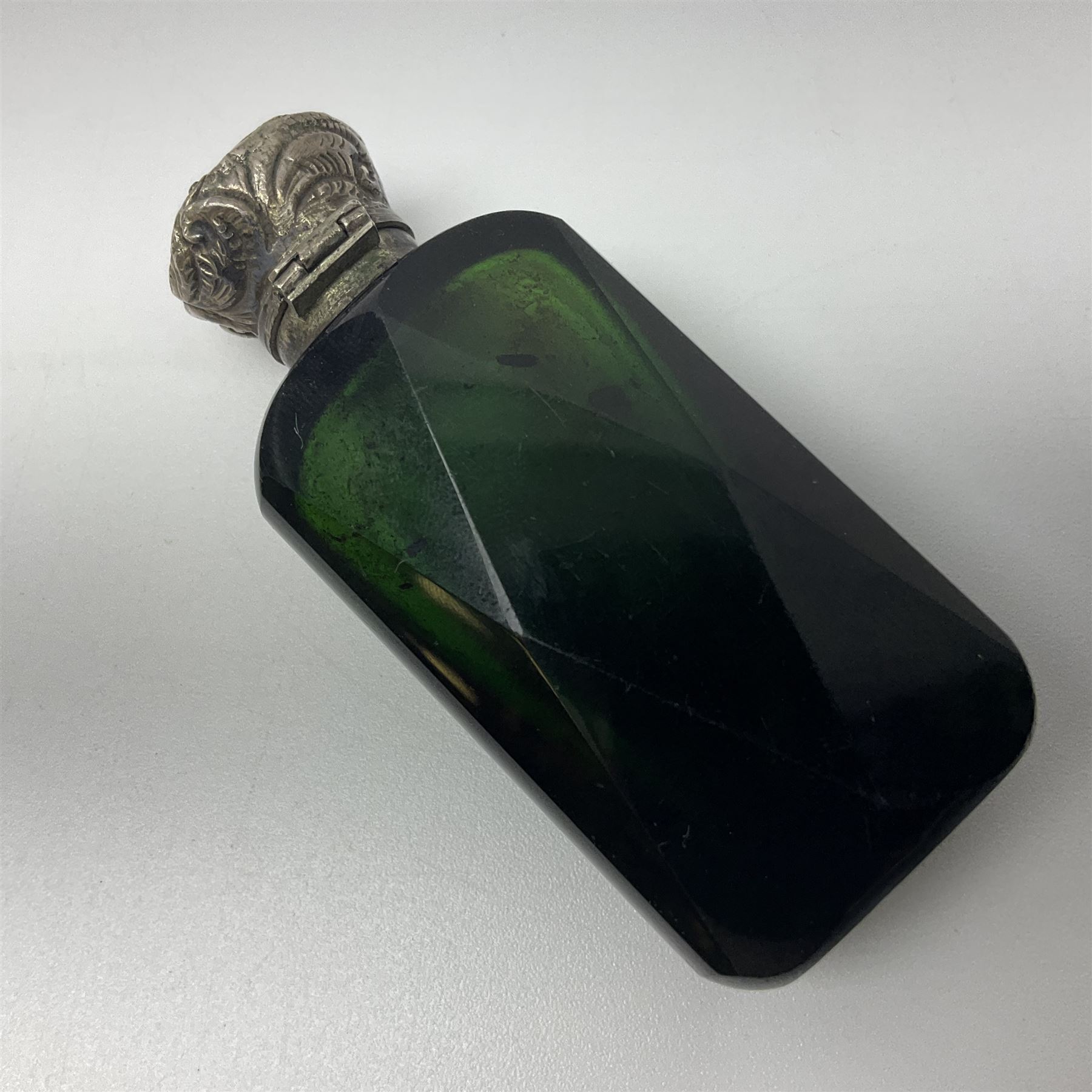 Silver mounted green glass scent bottle, with original stopper, and embossed silver cover, H7cm