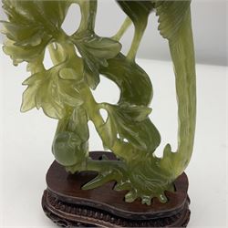 Carved jade figure of a phoenix perched on a flowering branch, upon a wooden stand, with original box, H27cm