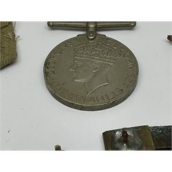 WWII group of three medals comprising 1939-45 War Medal and Italy and Africa Stars in issue box; dog tags for 282894 W. Wilkinson with framed photograph in uniform; and small quantity of cloth and metal badges including RAOC cap badge
