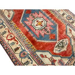 Anatolian Turkish ivory ground carpet, the central geometric pole medallion within an amber field, the guarded border decorated with stylised plant motifs surrounded by bands of repeating flower heads