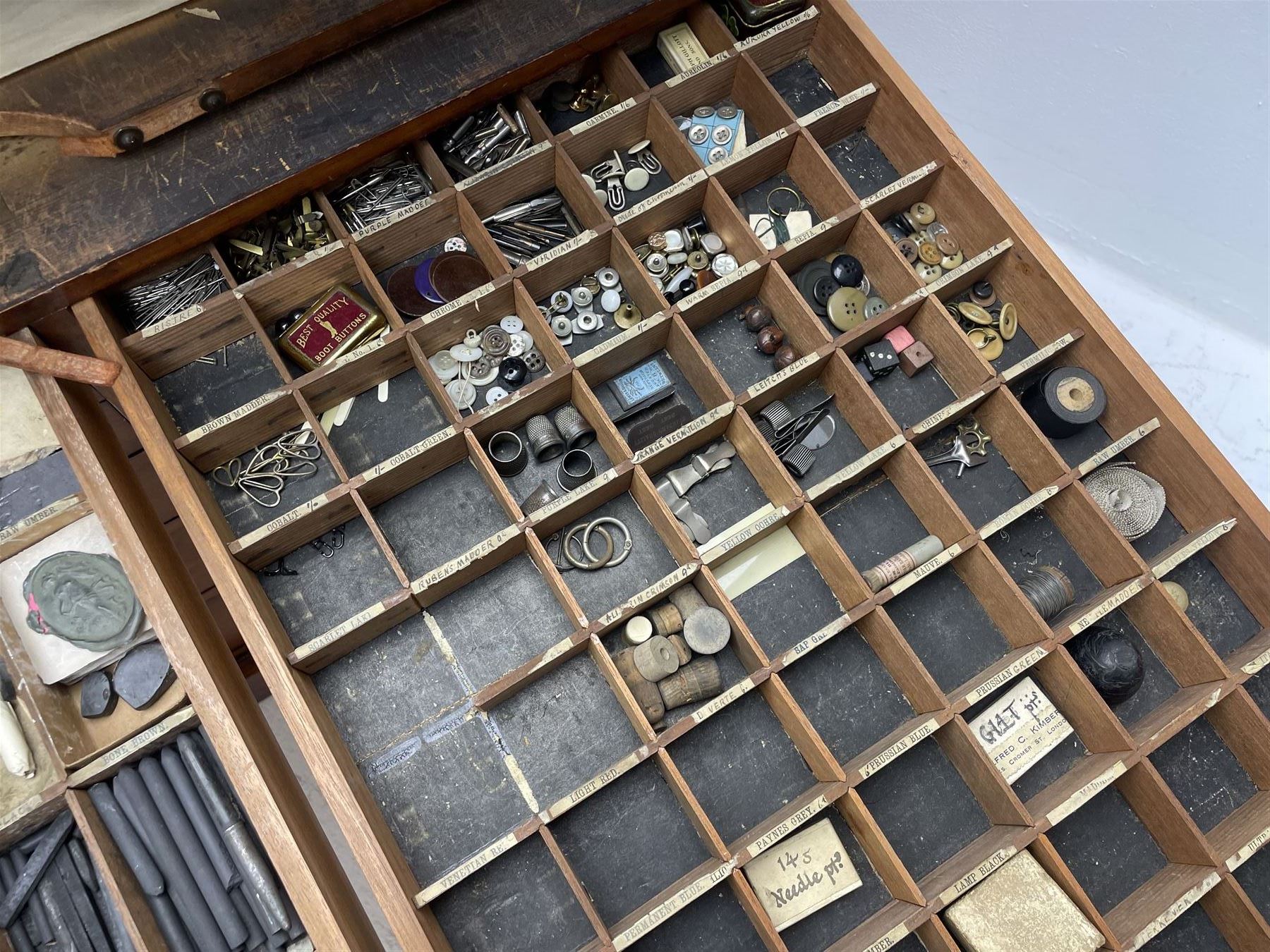Edwardian mahogany artist's cabinet once belonging to the British artist Eli Marsden Wilson (1877-1965), raised panelled back mounted by carved brackets, sloped and hinged glazed lid enclosing paint holders and compartments, up-and-over panelled door revealing three slides, fitted with two banks of five graduating drawers with recessed brass handles, on skirted base.

Together with a quantity of artists' equipment and tools including paints, paintbrushes, charcoal, chalks, etc. and various prints relating to the life of the artist, including Quaker anti-war posters, Victorian Stevengraphs, and various chromolithographs 

Provenance: Removed from the studio of Eli Marsden Wilson. The cabinet comes to us for sale through family descent. The vendor is descendant of Marsden. Many further etchings removed from the cabinet are being sold in the Spring Art Sale, Friday 15th March 2024, Lots 265-271.

Notes: born in Ossett, Eli Marsden Wilson was the only son of Alfred Wilson, a foreman beamer, and Emma Marsden, and had five sisters. After studying at Wakefield College of Art, he moved to the Royal College of Art in London, where he became a pupil of Sir Frank Short. He had his first exhibit at the Royal Academy in 1905, the same year he married fellow artist Hilda Mary Pemberton.

A Quaker, vegetarian, and pacifist, he was a conscientious objector in World War I and as such was imprisoned in 1917 for two years. In September 1922 he was commissioned by Princess Marie Louise to produce miniature etchings for Queen Mary's Dolls' House at Windsor Castle; two such etchings are being sold in the Spring Art Sale, Friday 15th March 2024, Lot 265.