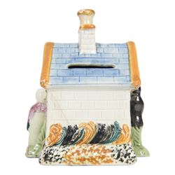 19th Century Staffordshire pearlware Prattware type money box, modelled as a houe with two figures to the front corners, H13cm