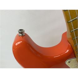 Japanese Squier Fender 'Hank Marvin' Stratocaster electric guitar, c1992, in Fiesta red with tremolo arm and facsimile signature decal; serial no.L037281, L98cm; in hard carrying case.