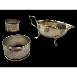 Silver cream jug and two napkin rings, all hallmarked 