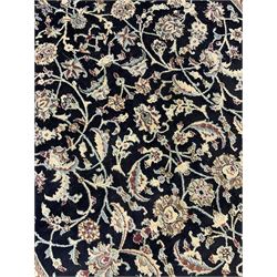 Central Persian part silk indigo ground Nain carpet, the field decorated with interlacing leafy branches and stylised plant motifs, scrolling design border within guard stripes 