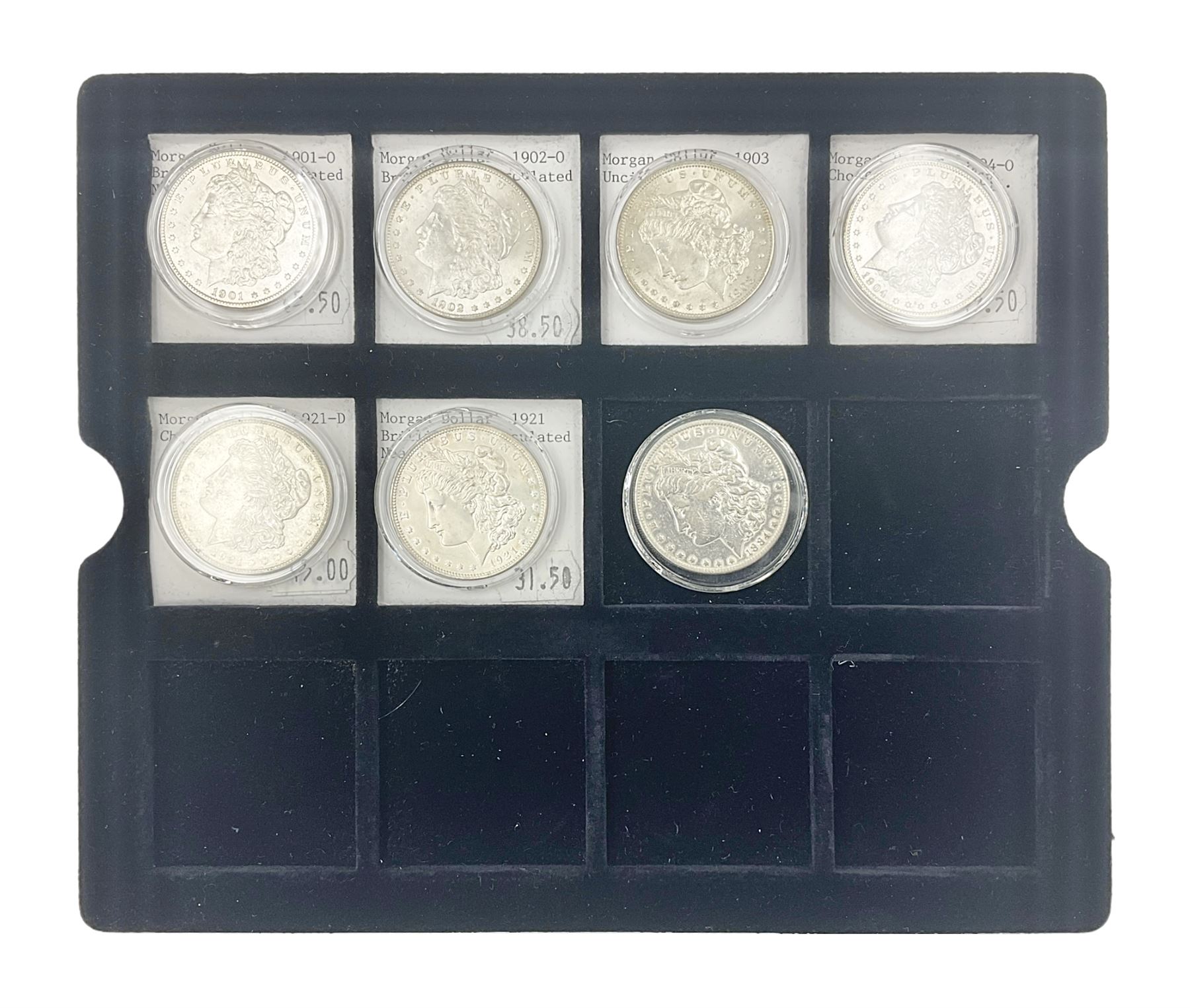 Seven United States of America silver Morgan dollar coins, dated 1884, 1901 O, 1902 O, 1903, 1904 O, 1921 D and 1921