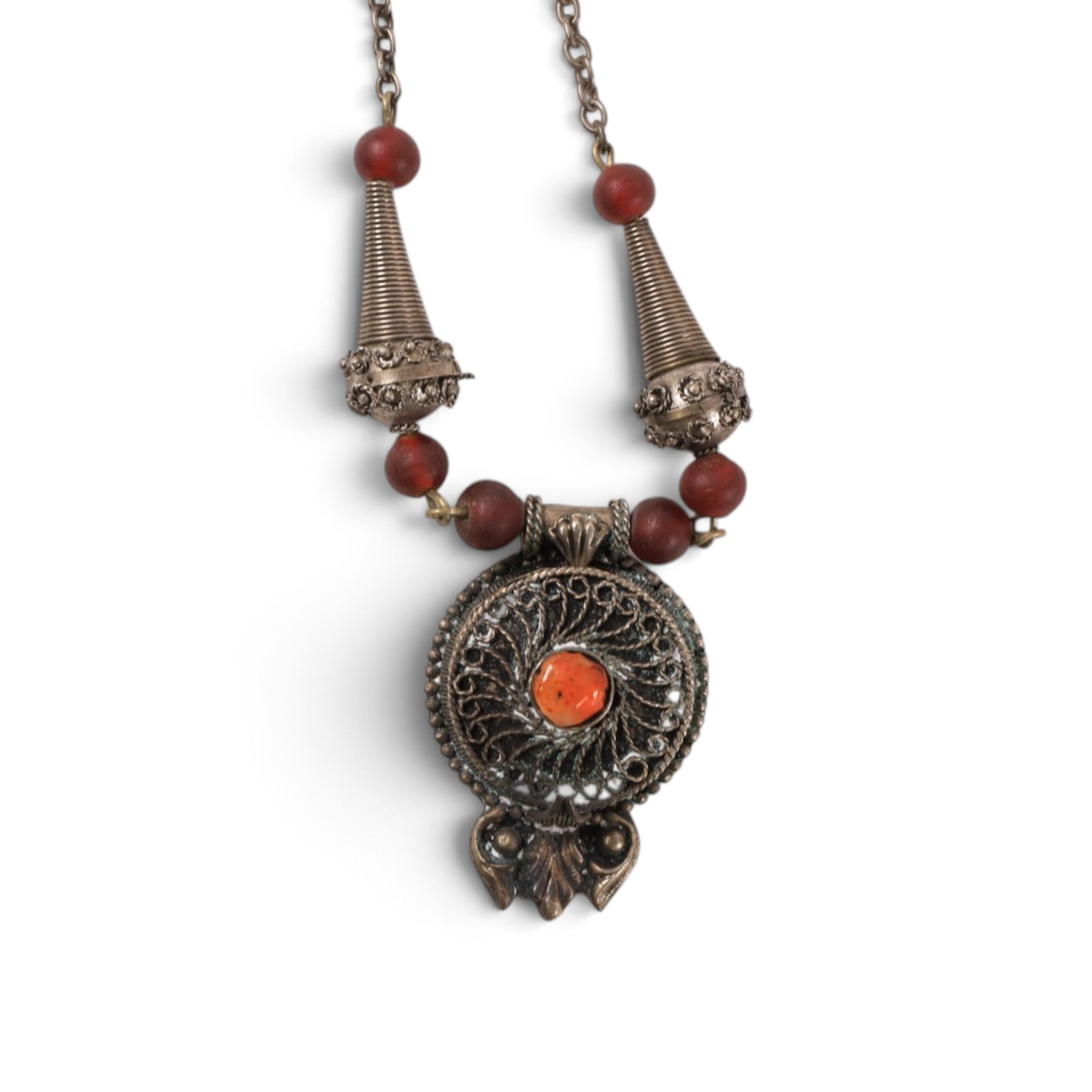 Collection of Middle Eastern jewellery, including silvered multi strand necklace with beadwork and filigree decoration with three cylindrical pendants, pendant necklace with central orange cabochon, beadwork choker and similar  
