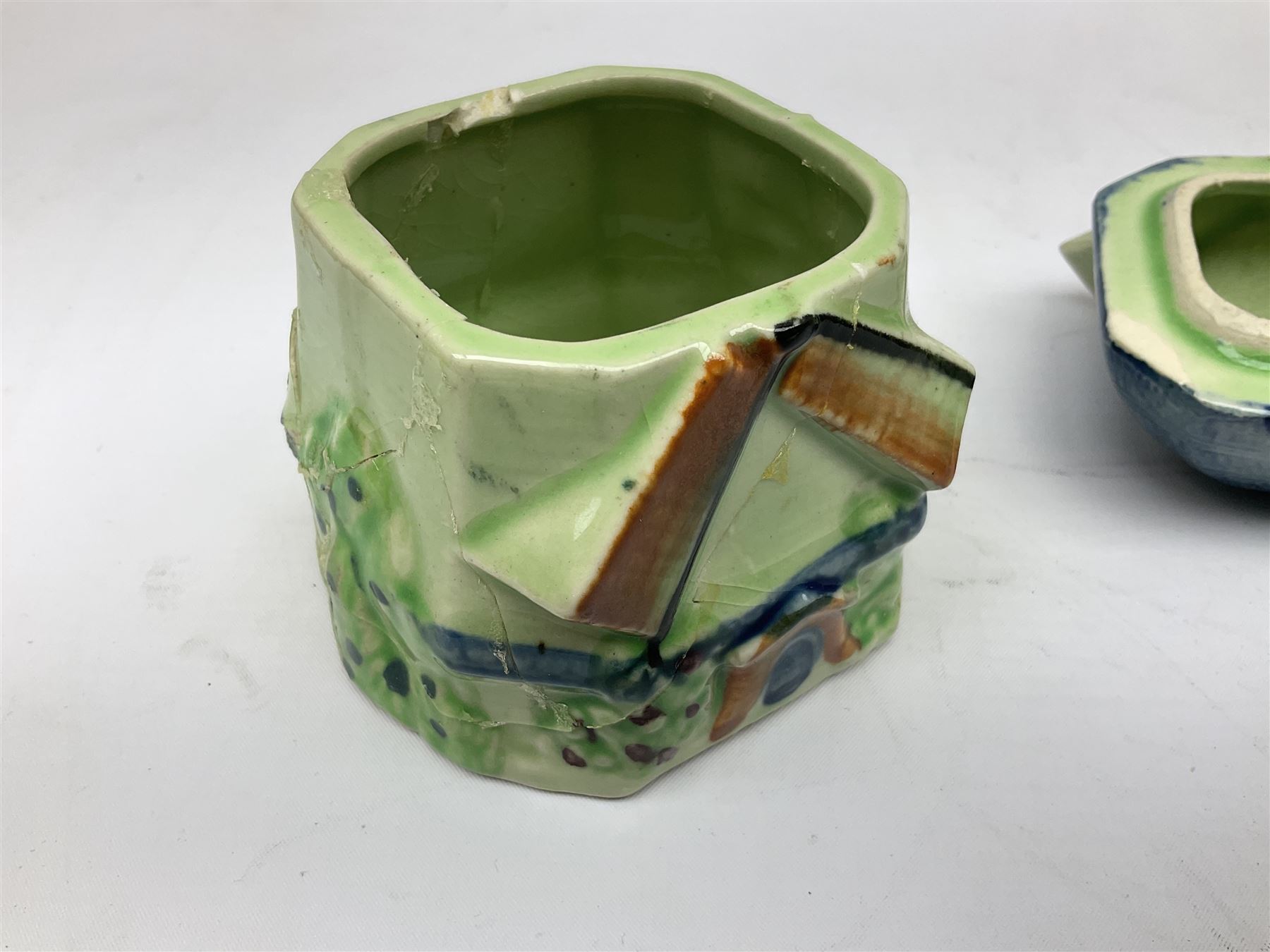Collection of Japanese Maruhon ware novelty preserve pots, to include examples modelled as a windmill and cottages, together with other 1920s and 30s Art Deco style preserve pots, etc