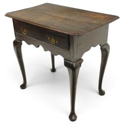 18th century oak lowboy, the rectangular top with moulded edge and eared front-corners, fitted with single drawer with pressed brass handle-plates, shaped apron over cabriole supports and pad feet