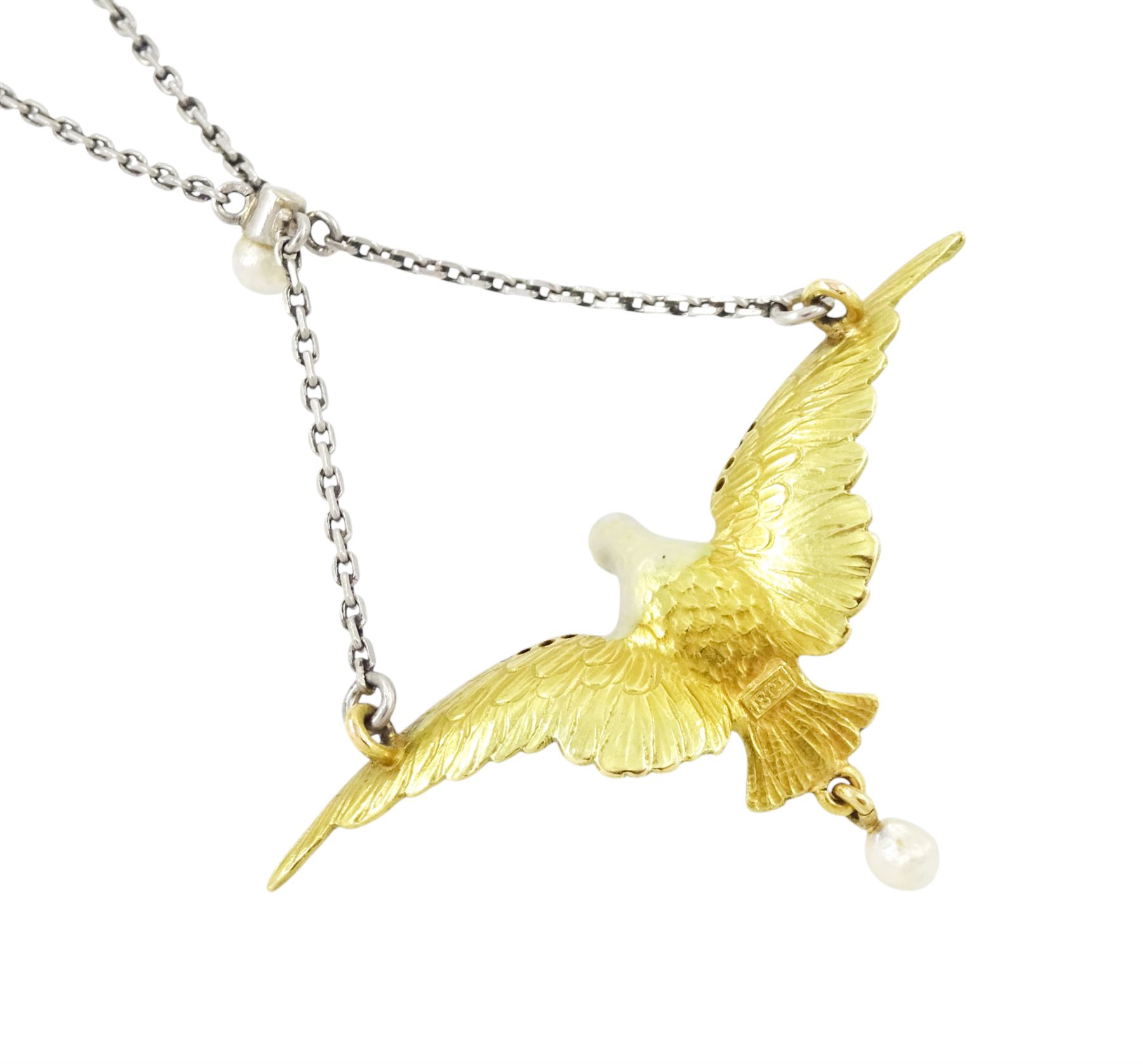 Early 20th century platinum and gold enamel, pearl and diamond dove pendant necklace, the dove in flight, with applied opalescent enamel, ruby set eyes and the wings outlined with rose cut diamonds, its claws holding a round cut ruby and suspending a pearl drop, stamped 18ct, to a platinum chain set with an additional pearl
