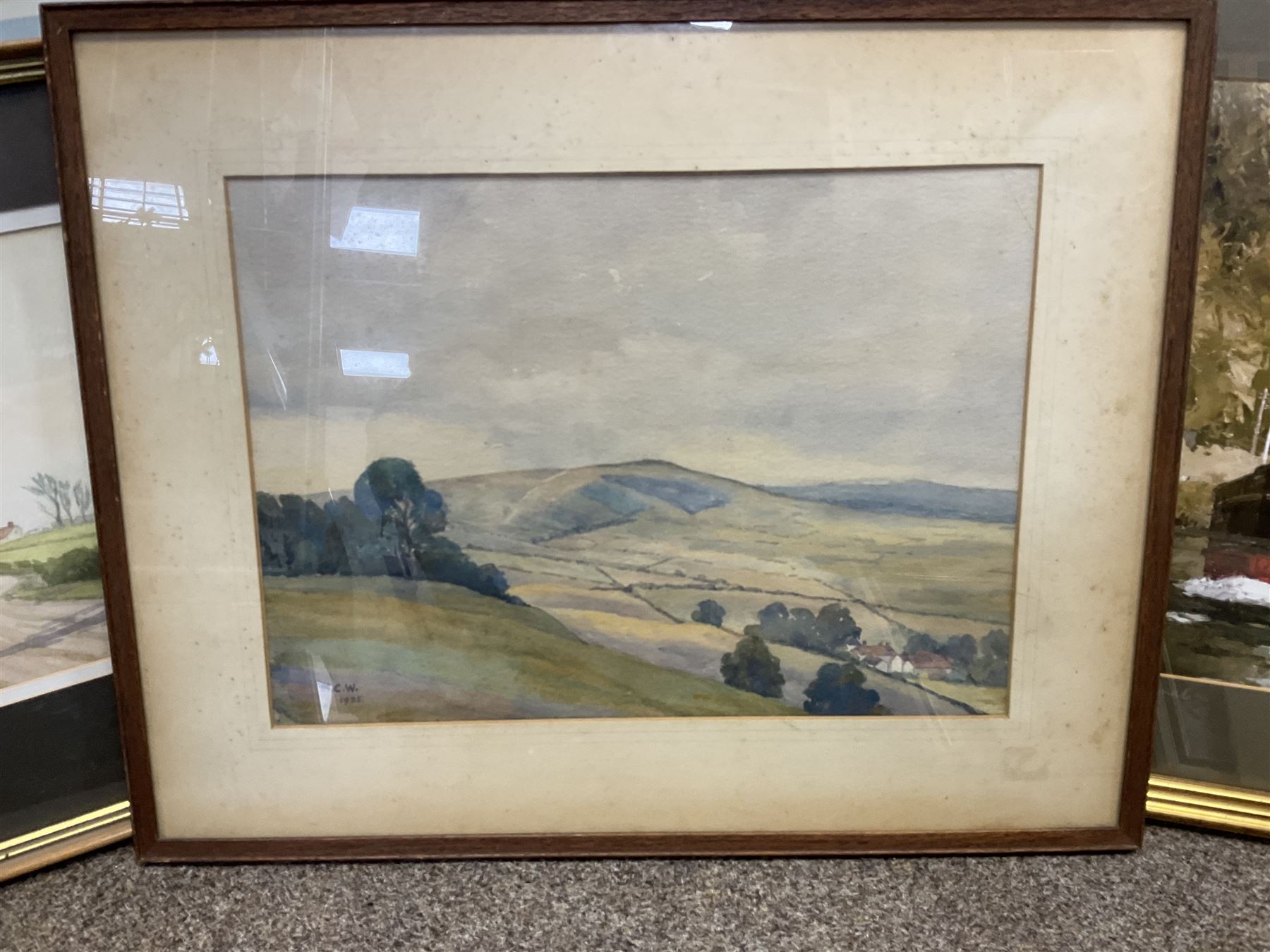 G A Townsend (British 20th century) 'The Trout Inn', watercolor signed and dated; M C W (British 20th century) The Wolds watercolor signed and dates, together with another watercolour and three landscape prints