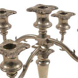 Silver plate two branch candelabra with grape vine decoration to the base, together with a matching pair of candle sticks and other candlesticks  