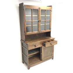Vintage oak dresser raised back with two glazed doors enclosing shelves above two sliding base drawers 