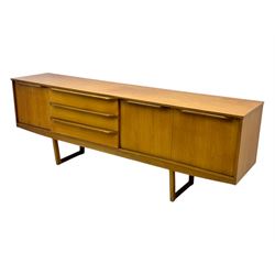 Mid-20th century teak sideboard, fitted with a fall-front cupboard, three drawers including a green baize-lined cutlery drawer, and a double cupboard, with integrated handles, on sleigh supports