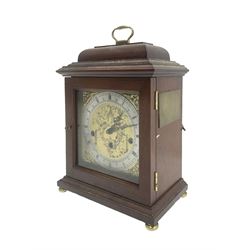 Hermle - German 8-day 20th century quarter chiming mantle clock , in a mahogany case with a moulded top and carrying  handle,  square brass dial with a silvered chapter ring and cast brass spandrels, with a floating balance escapement chiming the quarters and hours on 5 gong rods. With key.