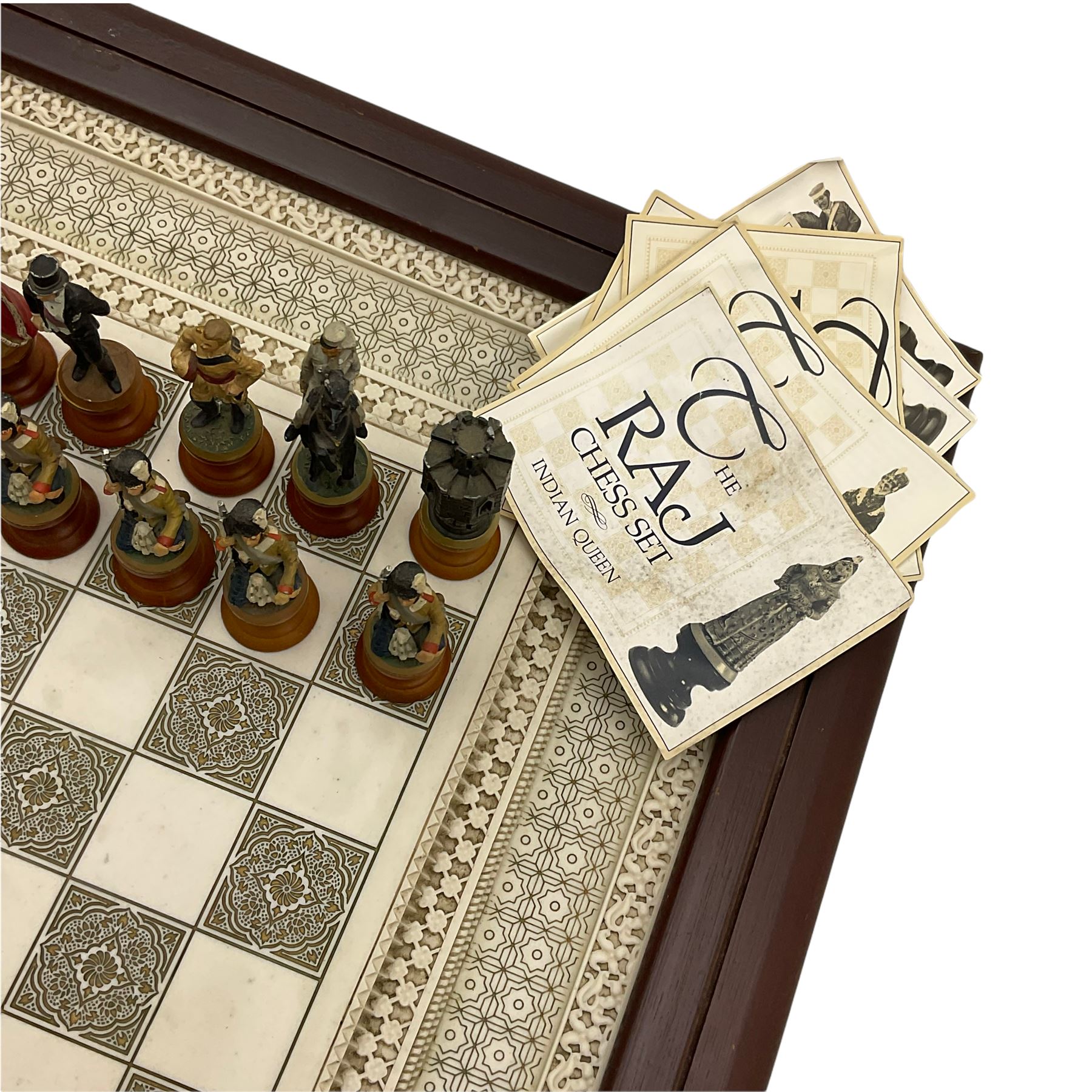 Franklin Mint Indian ' The Raj ' chess set with marble effect chess board within a mahogany stained frame raised on a brass mounted pedestal base with single fitted drawer, the playing pieces depicting figures from the 1857 Raj mutiny 52cm square H68cm