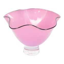 Gillies Jones pink glass bowl with crimped black rim upon a pedestal foot, H11cm