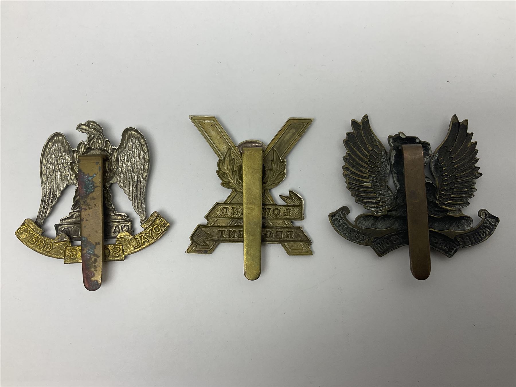 Fifteen Scottish Glengarry and other metal military badges including Argyll & Sutherland, Royal Glasgow Yeomanry, Cameronians, Lanarkshire Yeomanry, Kings Scottish Own Borderers, Highland Light Infantry, Border Regiment, Lowland Regiment, Lothians & Border Horse Yeomanry, Ayrshire Earl of Carricks Own Yeomanry etc