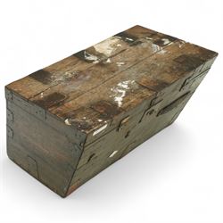 19th century metal bound ship’s trunk, of trapezoidal form with hinged lid, iron strapwork and corner reinforcements, remains of paper lining to interior