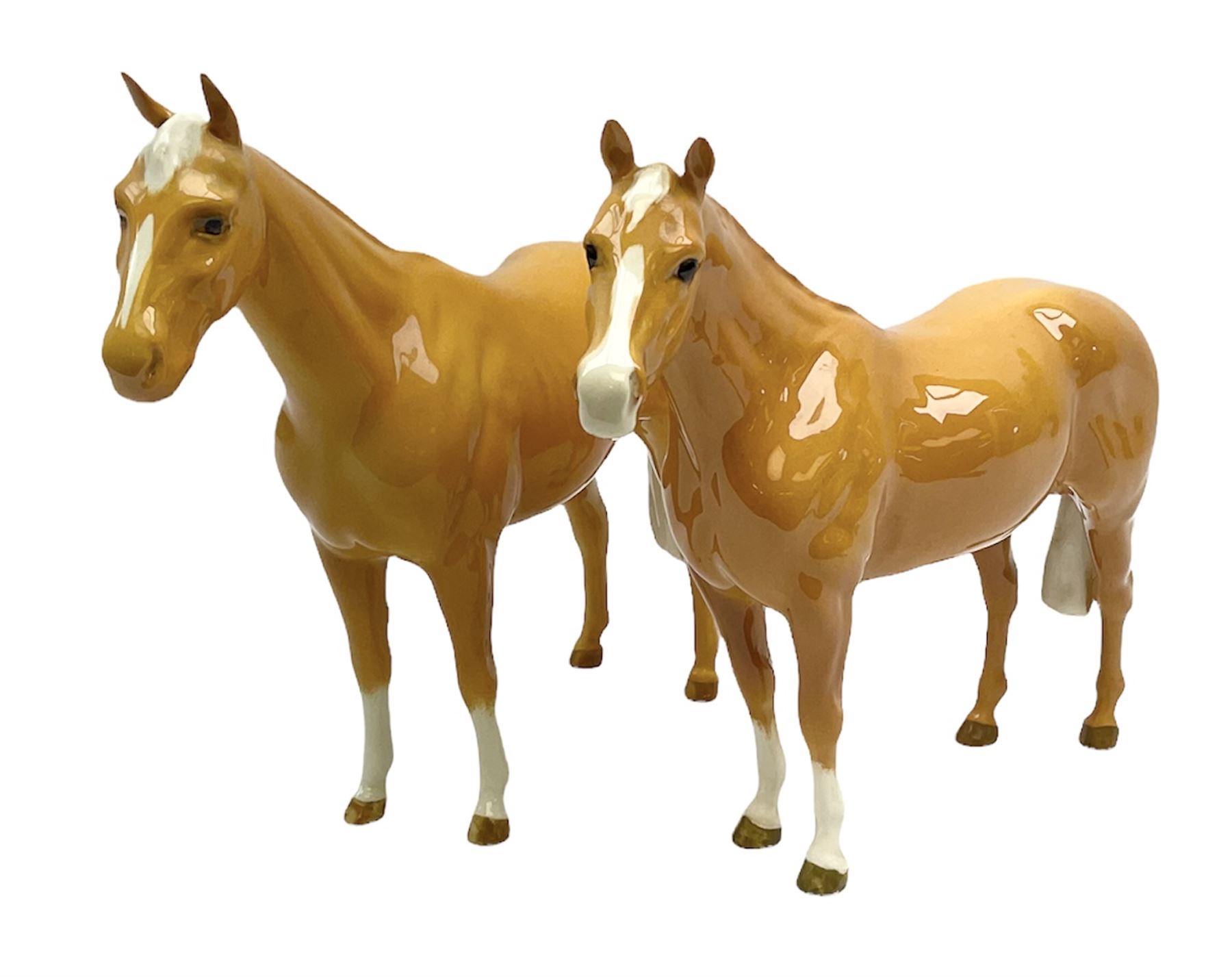 Two Beswick Palomino horse figures, comprising 'Imperial' Palomino, model no. 1557, designed by Albert Hallam and James Hayward, together with Palomino Arab model no. 1771, both stamped, tallest H20cm