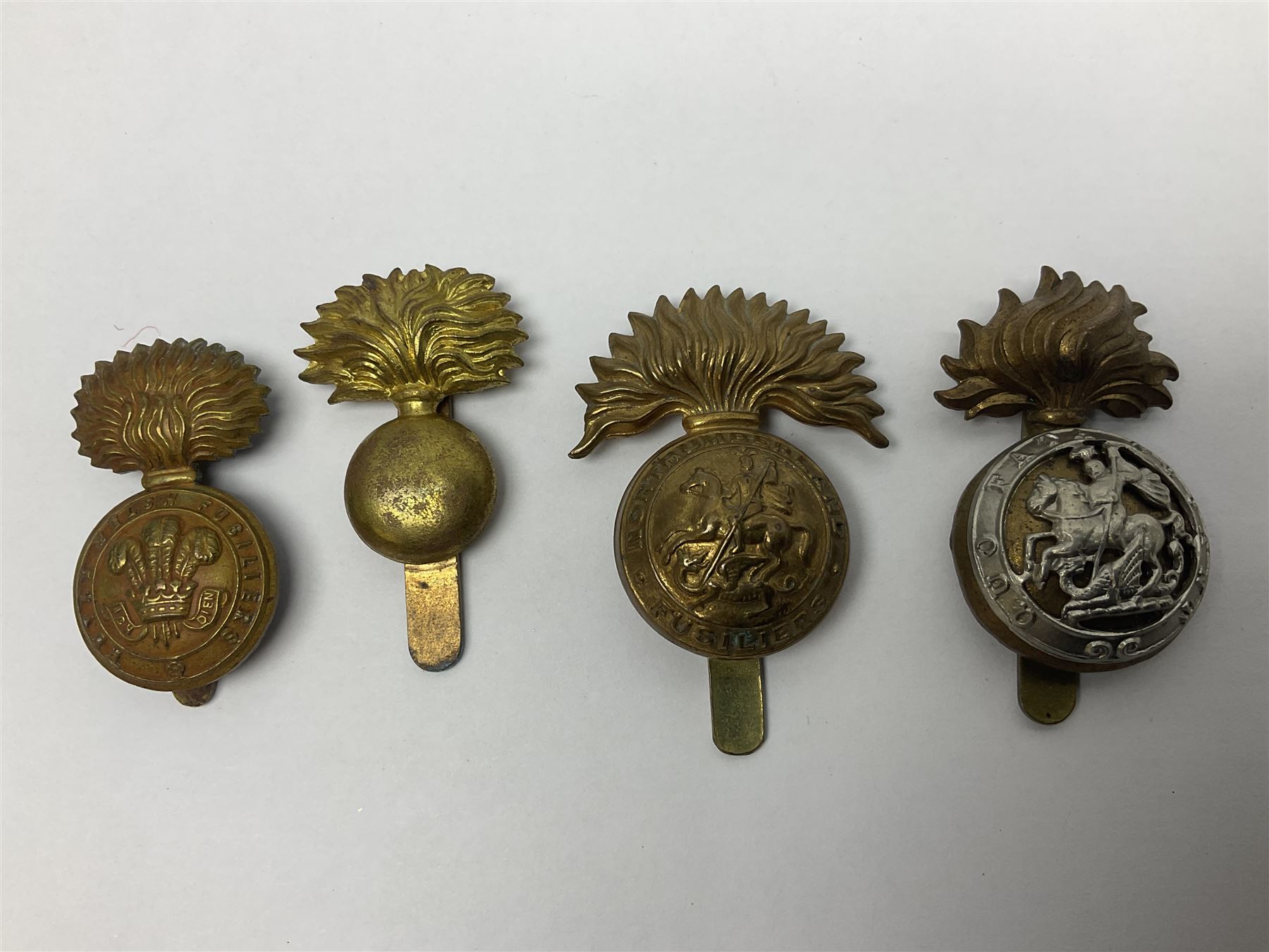 Nineteen Yeomanry metal cap badges including Derbyshire, Northamptonshire, Essex, Glamorgan, Staffordshire, City of London, Surrey, Shropshire, Hertfordshire etc; together with eleven Fusiliers badges including Lancashire, Royal Welch, Northumberland etc (30)